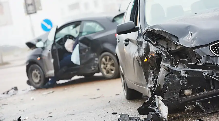 A car showing signs of a recent crash, with visible dents and scratches.
