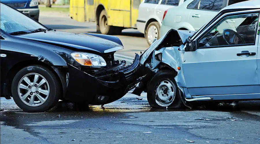 Two damaged cars after a collision on the road.